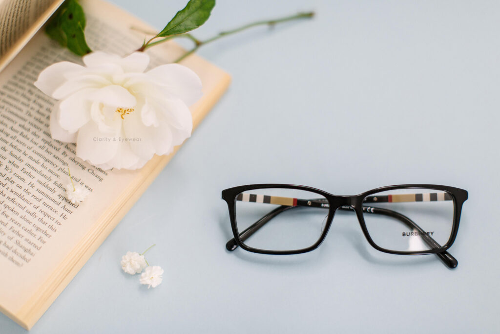 black burberry squarish frame with a book and flower