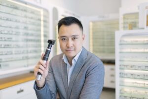 Male Optometrist holding a scope