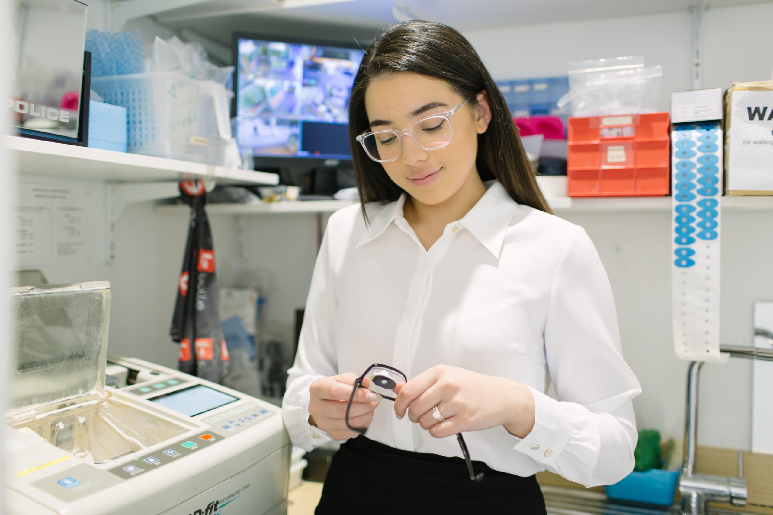 A girl fitting glasses in a optical lab